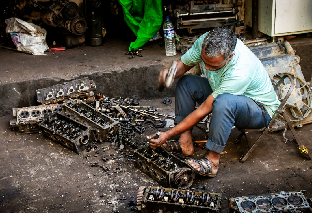 Professional mechanic examining detailed car engine components in modern workshop