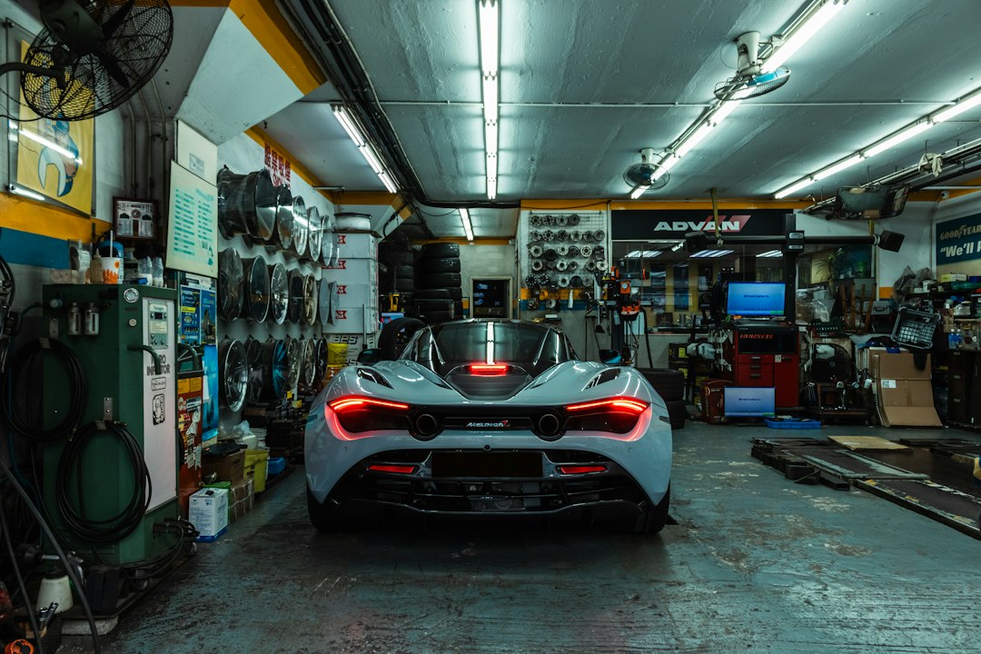 Professional car service center with mechanics working in modern facility